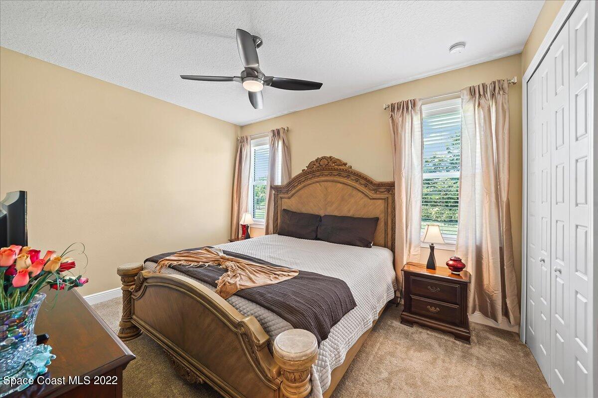 1360 Corey Road Malabar, FL 32950 - Photo 14 of 48 a bedroom with a bed and a chandelier