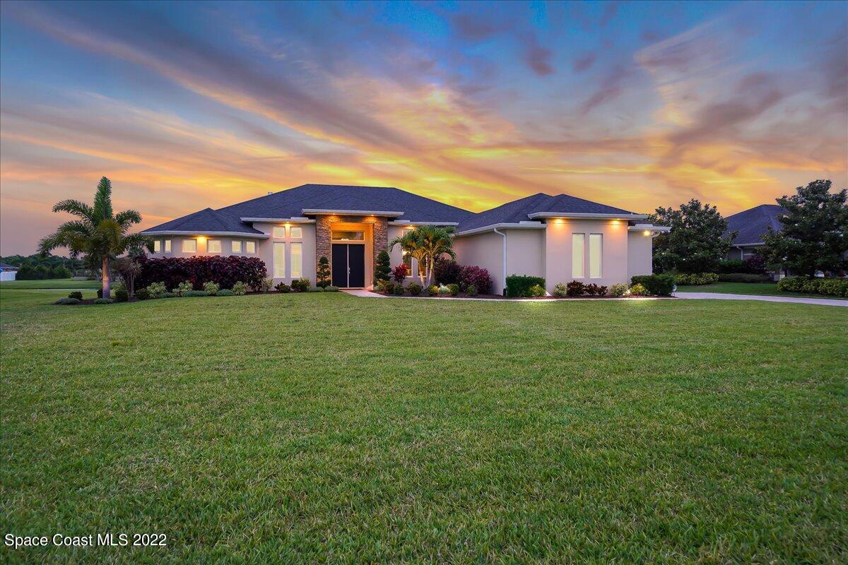 1360 Corey Road Malabar, FL 32950 - Photo 45 of 48 a large house with a big yard and large trees