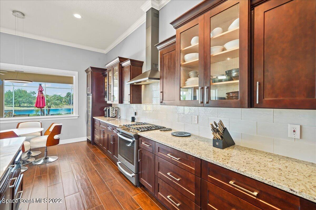 1360 Corey Road Malabar, FL 32950 - Photo 8 of 48 a kitchen with a sink a stove and cabinets