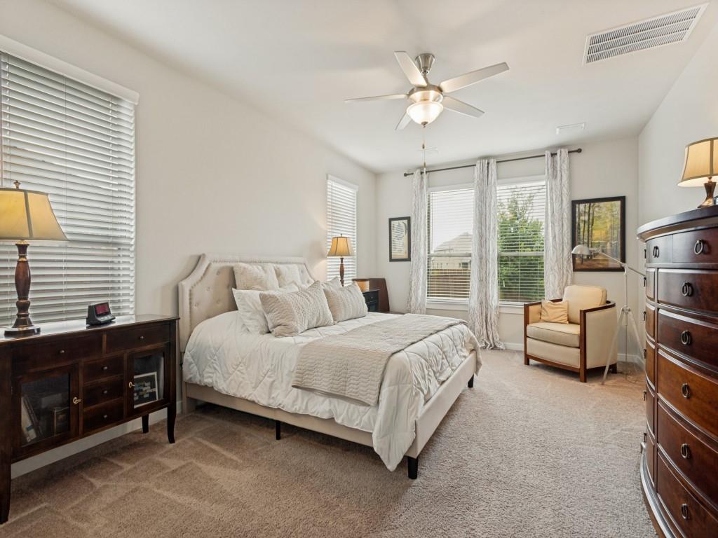 10613 Smiths Bnd Road Fort Worth, TX 76126 - Photo 22 of 29 Carpeted bedroom featuring multiple windows with blinds, a ceiling fan with integrated lighting, and a neutral color palette