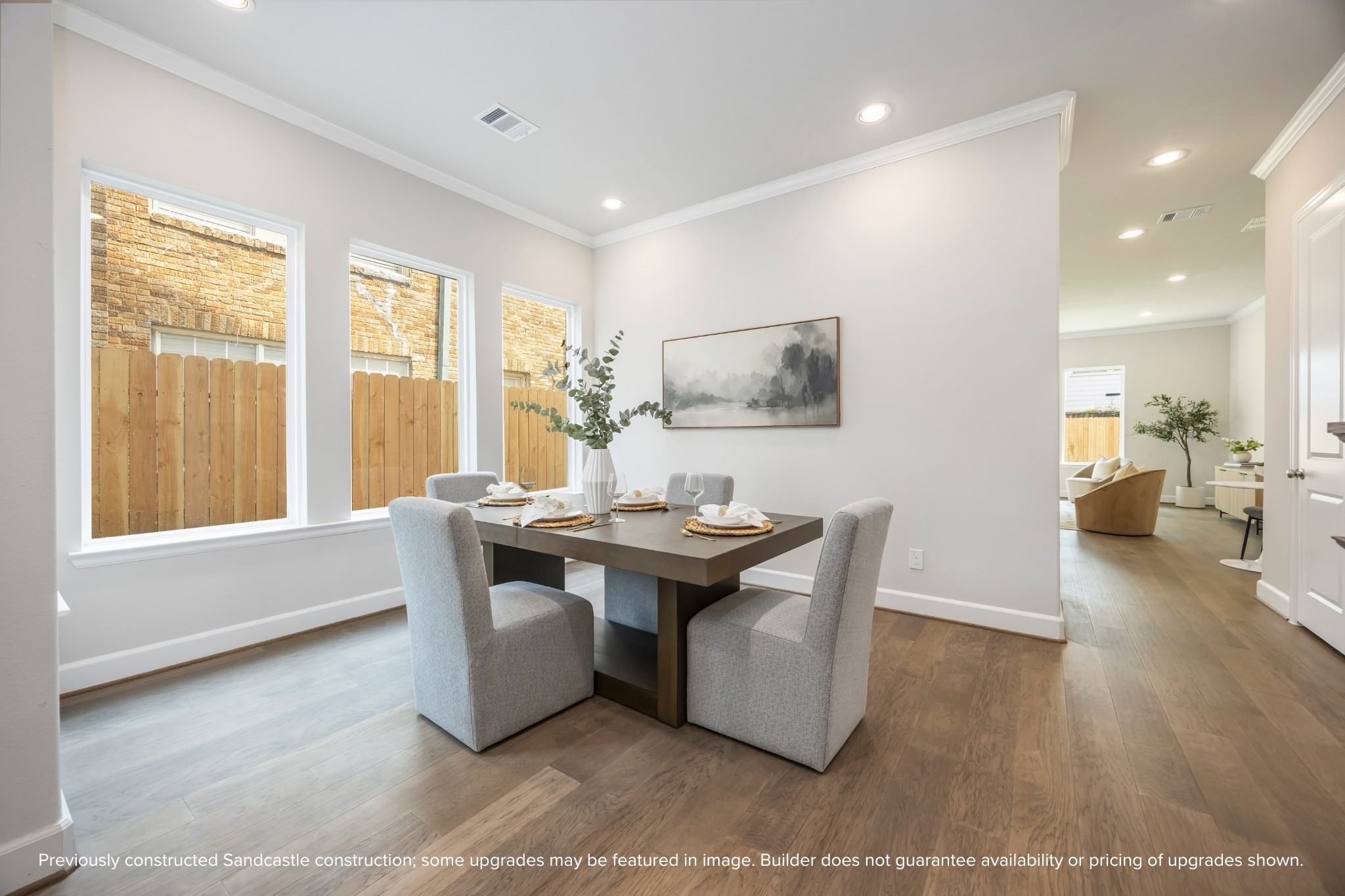 4317 Roseland Street, Unit B Houston, TX 77006 - Photo 16 of 36 a view of a living room and kitchen with furniture wooden floor and a large window