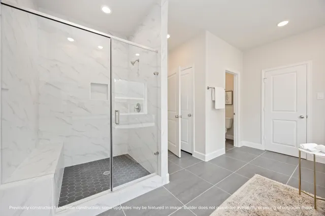 a bathroom with a shower and a glass door