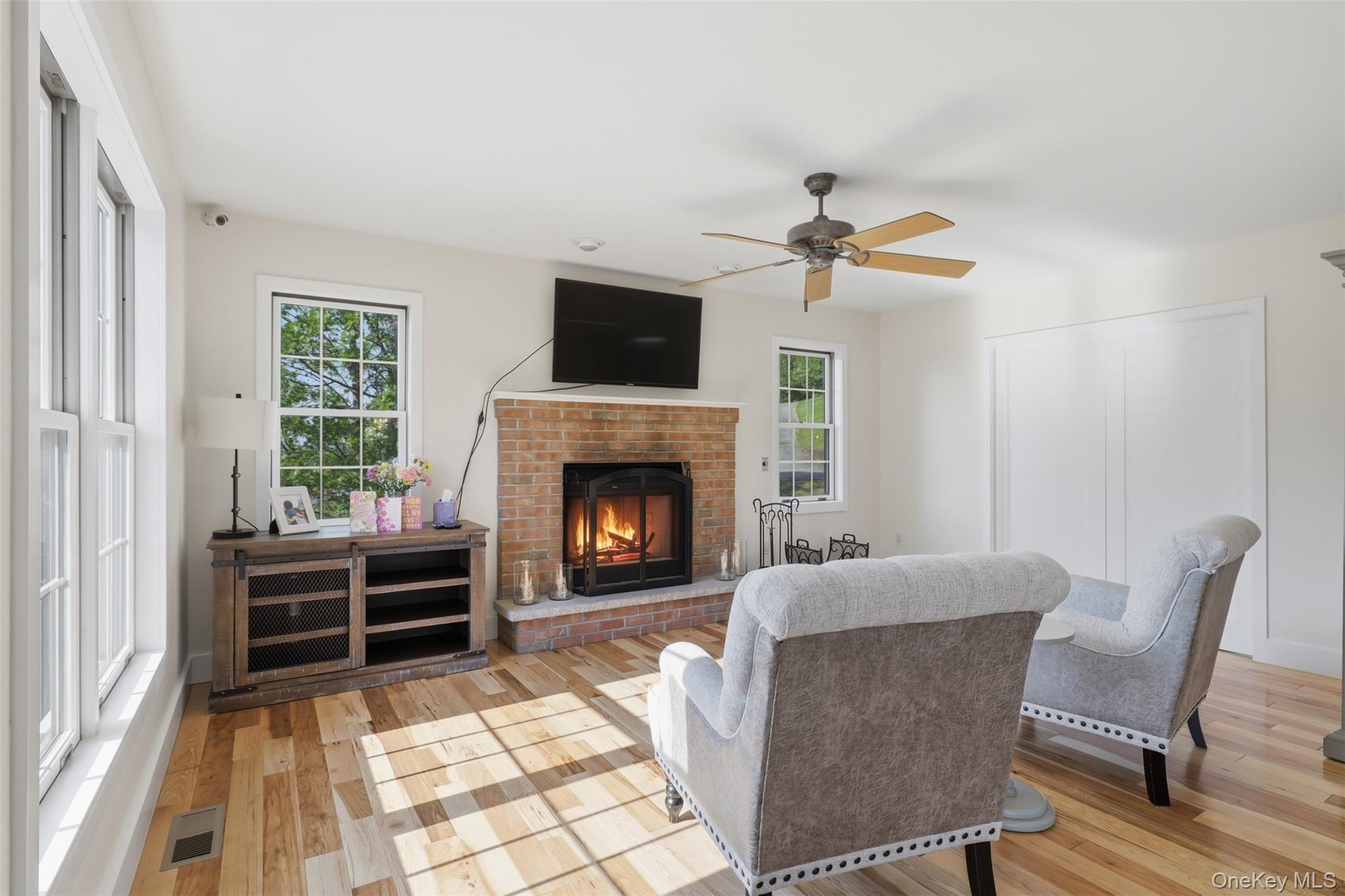 233 Devon Farms Road Stormville, NY 12582 - Photo 12 of 48 a living room with furniture a flat screen tv and a fireplace