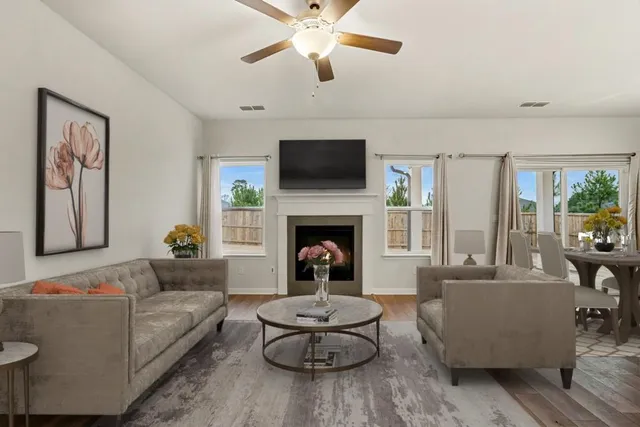 a living room with furniture and a fireplace