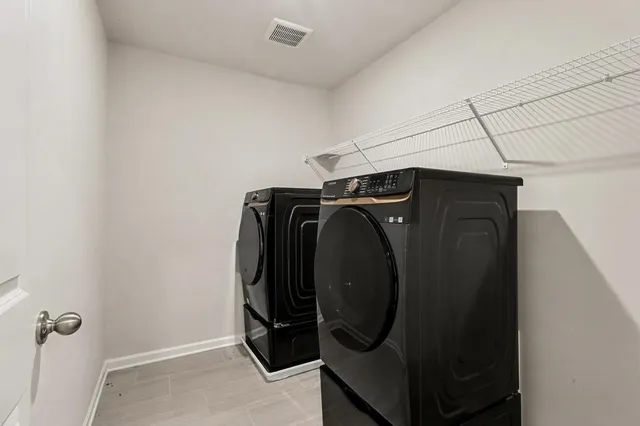 an aerial view of a house with a yard garage and lake view