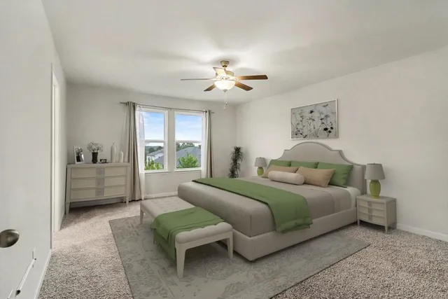 a bedroom with a bed couches and a flat tv screen