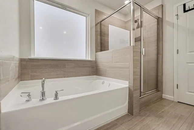 a bathroom with a bathtub and a shower