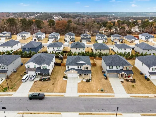 an aerial view of residential houses with outdoor space