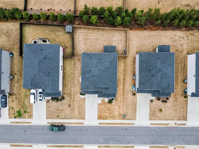 an aerial view of houses with outdoor space