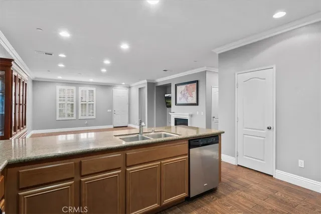 a view of a kitchen with granite countertop stainless steel appliances cabinets a sink and a counter top space