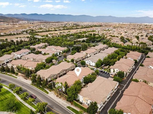 an aerial view of a house with a yard