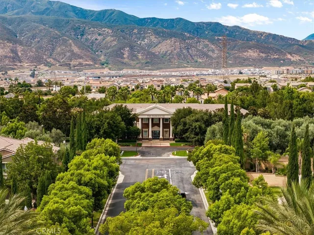 an aerial view of residential houses with outdoor space and mountain view in back