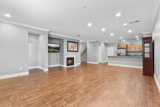 an empty room with windows and fireplace