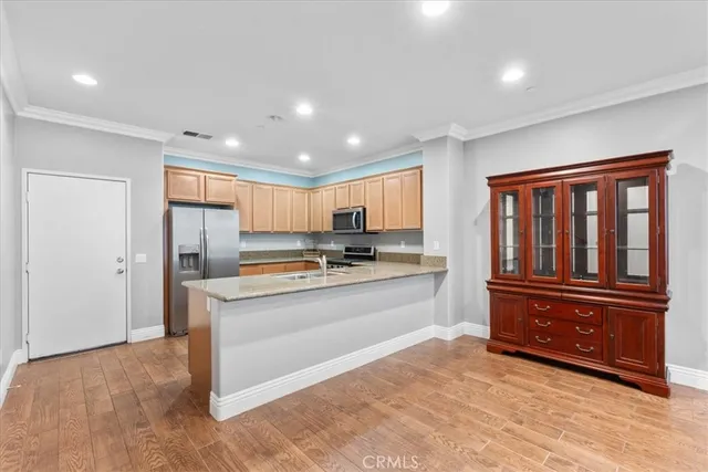 a kitchen with stainless steel appliances granite countertop a stove and a sink
