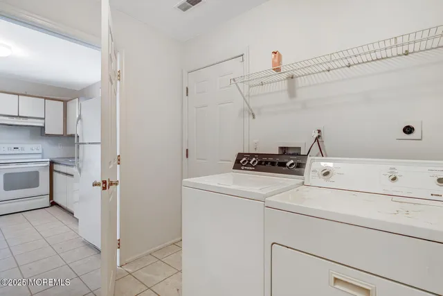 a view of storage and utility room with washer and dryer