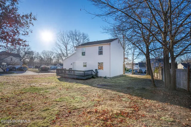 a view of a yard with snow on the side of the road