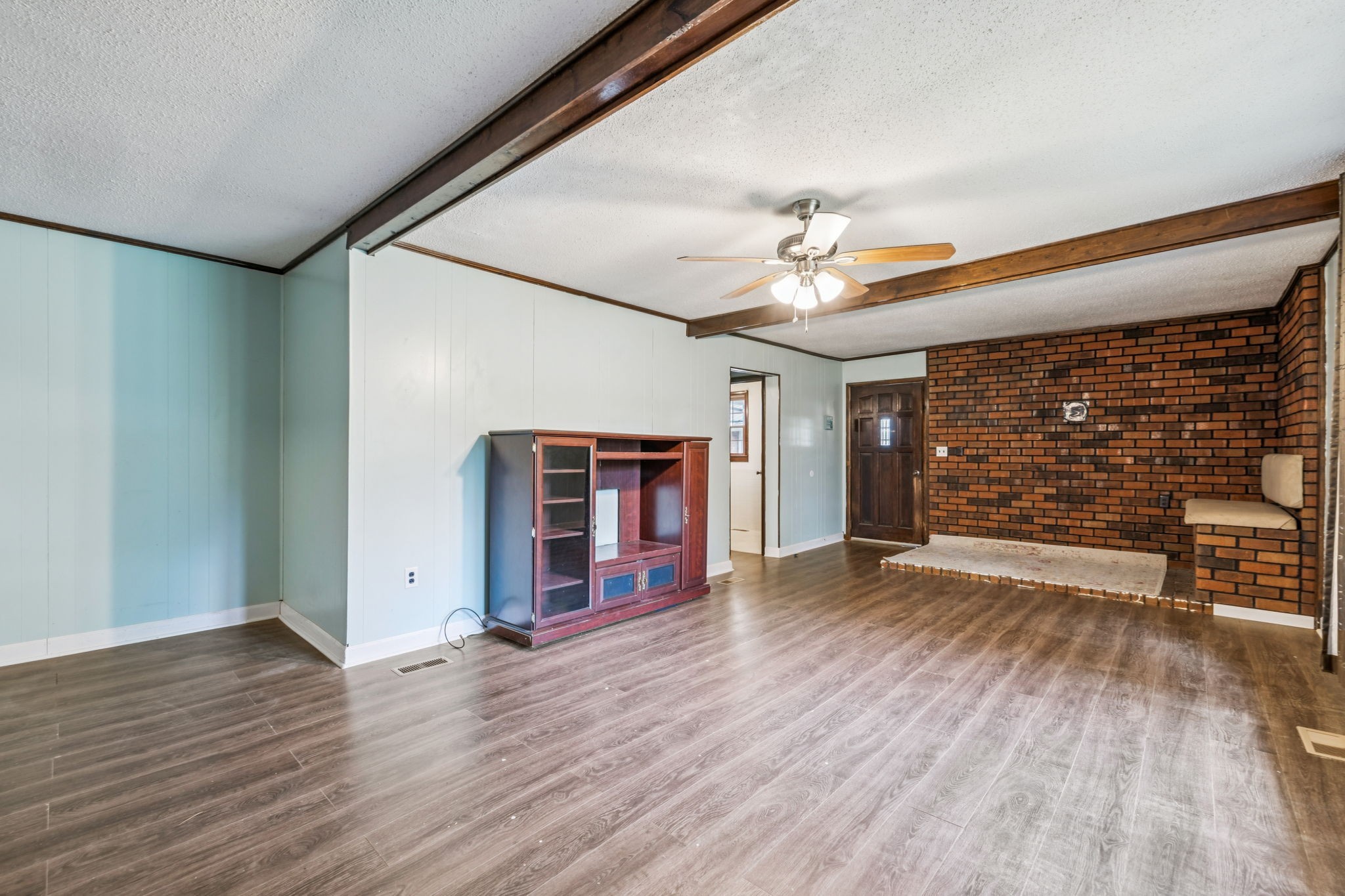 588 Sweeton Hill Road Coalmont, TN 37313 - Photo 29 of 51 a view of a livingroom with wooden floor and a ceiling fan