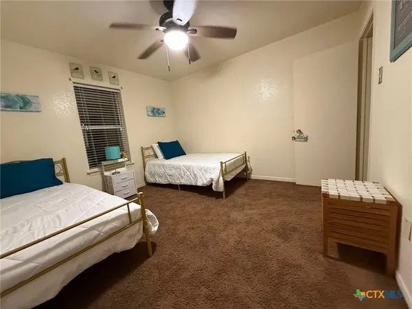 a bedroom with a bed and ceiling fan