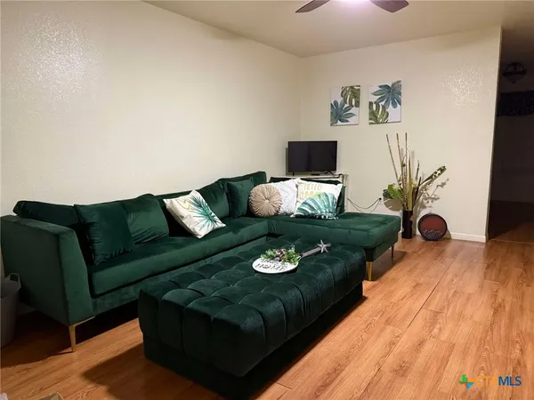 a living room with furniture and wooden floor