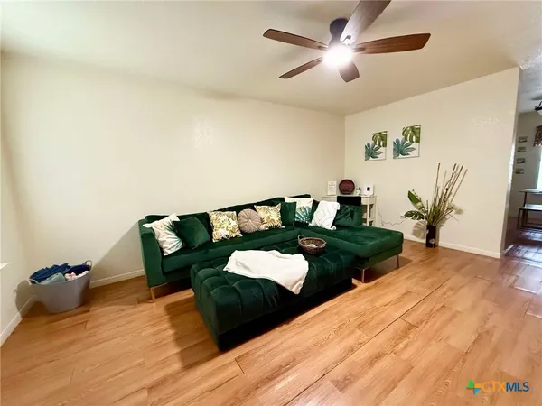 a bed room with two bed and a potted plant