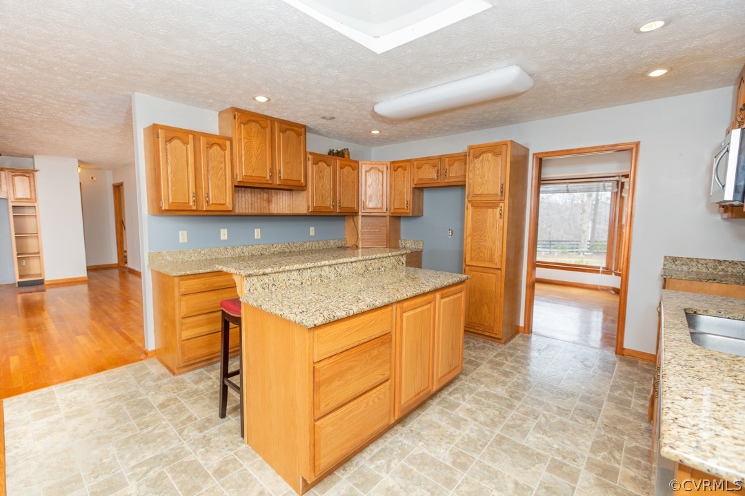 5584 The Falls Road Crewe, VA 23930 - Photo 4 of 29 a kitchen with granite countertop a stove and a refrigerator