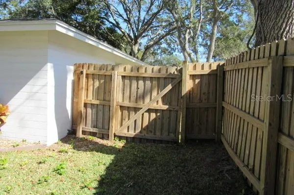 a view of wooden house with a small yard