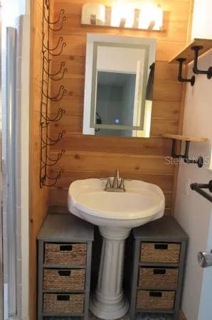 a bathroom with a sink and a mirror