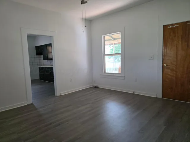 a white toilet sitting in a bathroom next to a window
