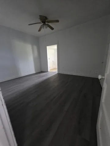 a view of a room with wooden floor