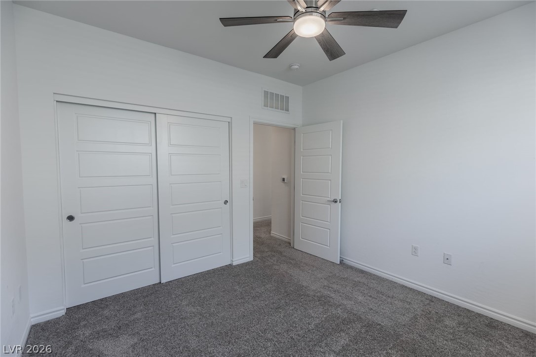 2555 Hampton Road, Unit 8206 Henderson, NV 89052 - Photo 20 of 35 This inviting bedroom features soft carpeting and ample natural light, creating a bright and comfortable atmosphere.