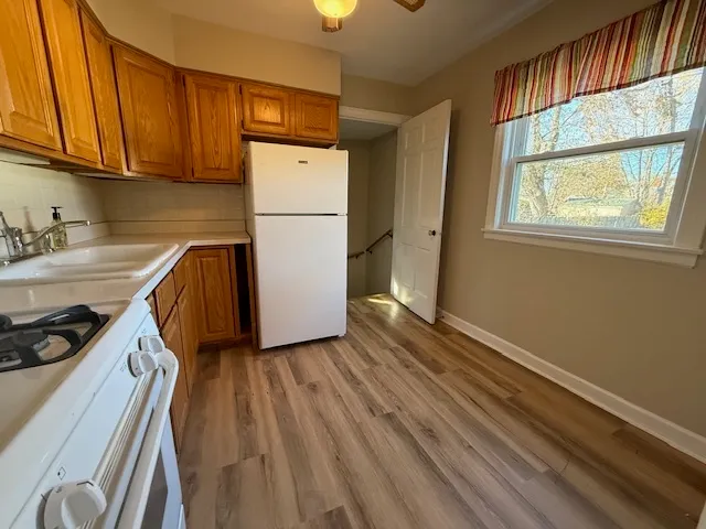 a kitchen with sink a refrigerator and cabinets