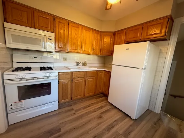 a kitchen with a white cabinets and white appliances
