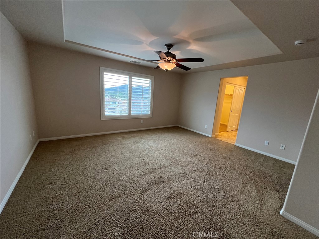 35429 Saddle Hill Road Lake Elsinore, CA 92532 - Photo 21 of 27 an empty room with a window and a ceiling fan