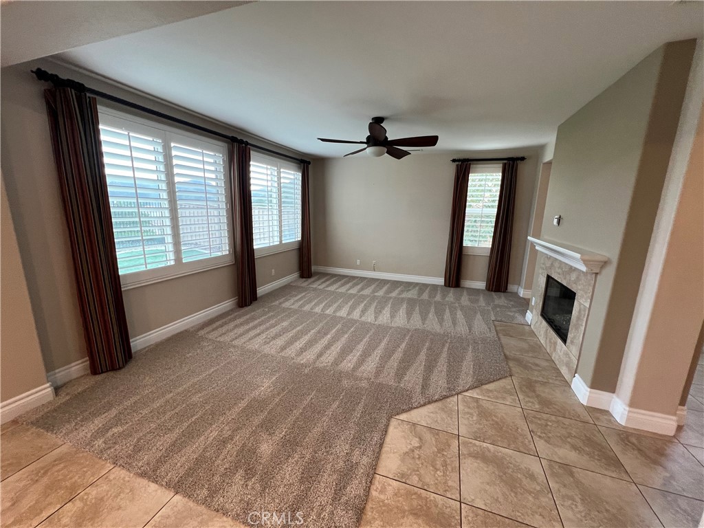 35429 Saddle Hill Road Lake Elsinore, CA 92532 - Photo 10 of 27 a view of an empty room with a fireplace and a window