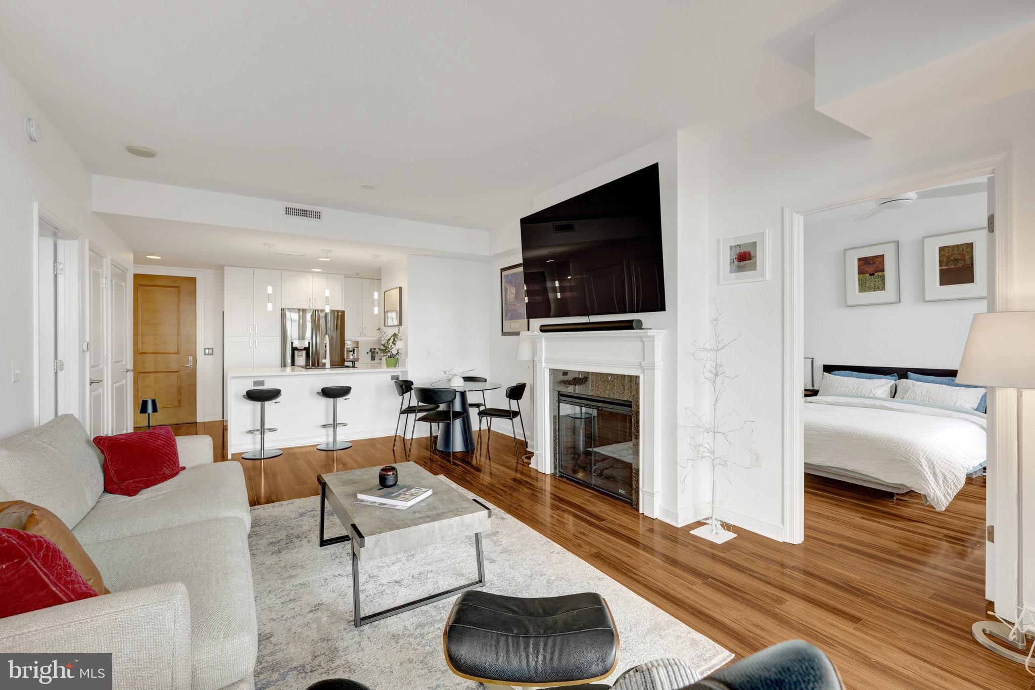 11990 Market Street, Unit 614 Reston, VA 20190 - Photo 21 of 43 a living room with furniture and a flat screen tv