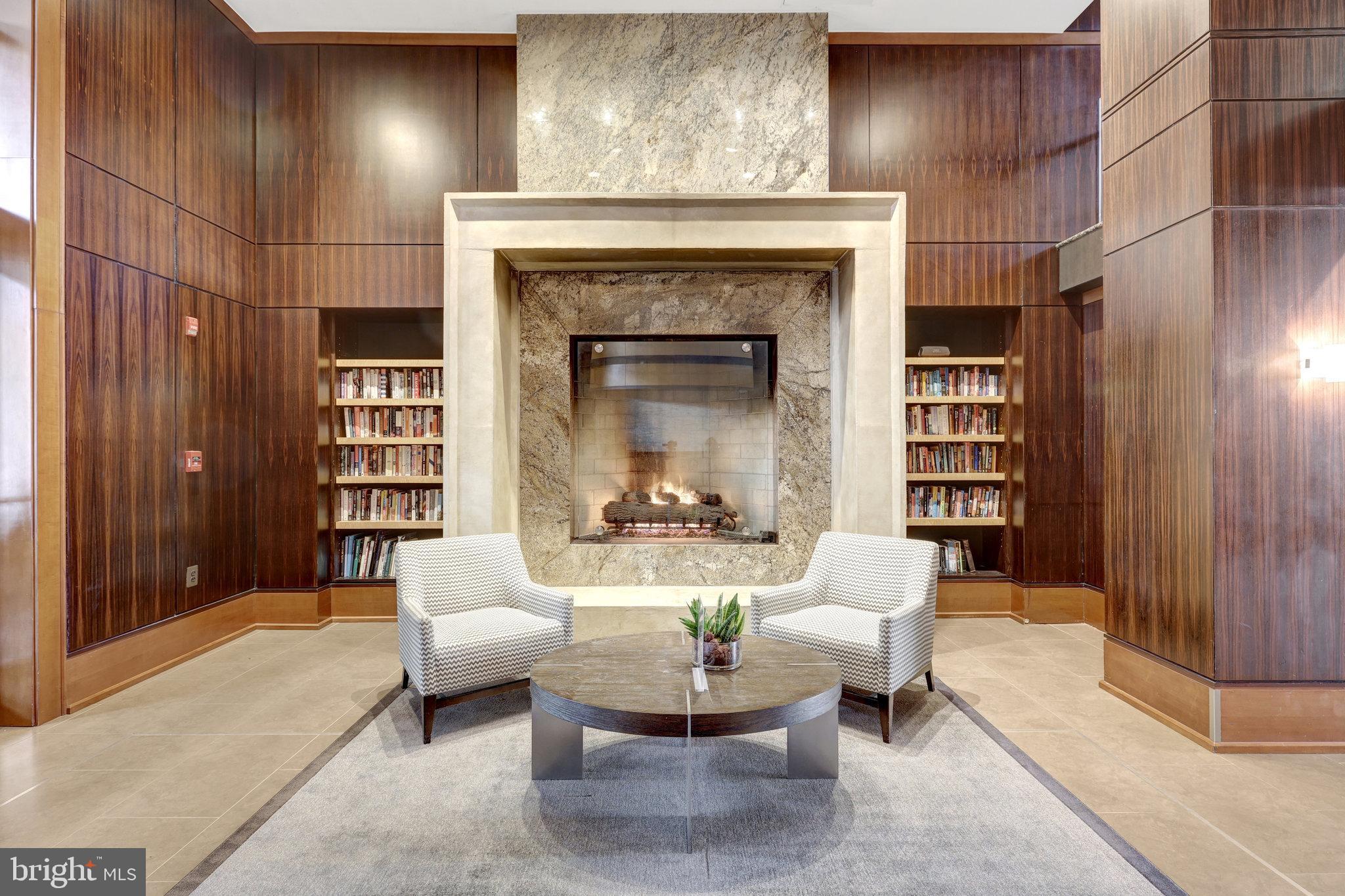 11990 Market Street, Unit 614 Reston, VA 20190 - Photo 5 of 43 a living room with furniture a fireplace and a chandelier