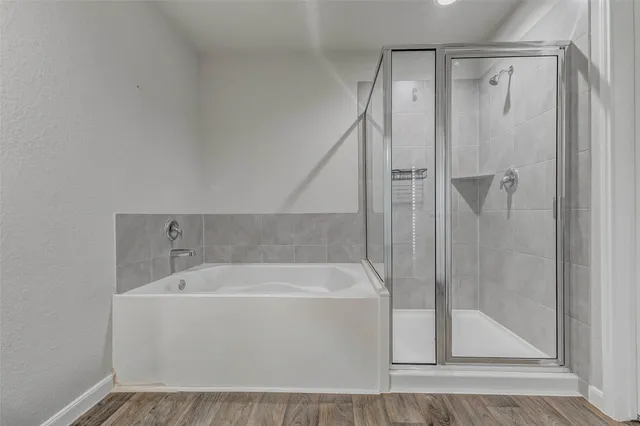 a white bath tub sitting next to a shower