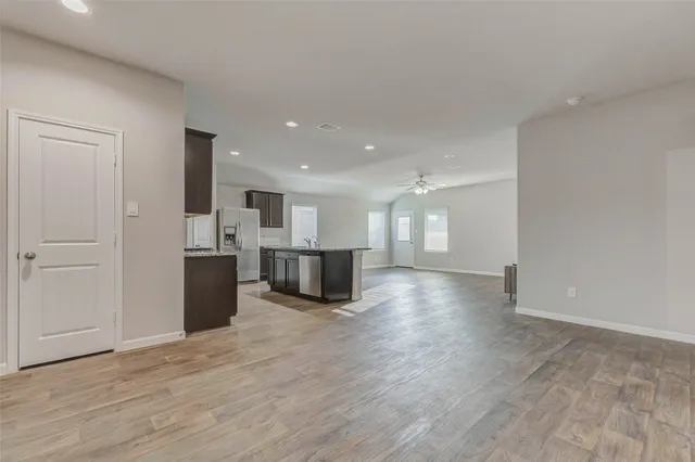 a view of a kitchen with a sink and a refrigerator