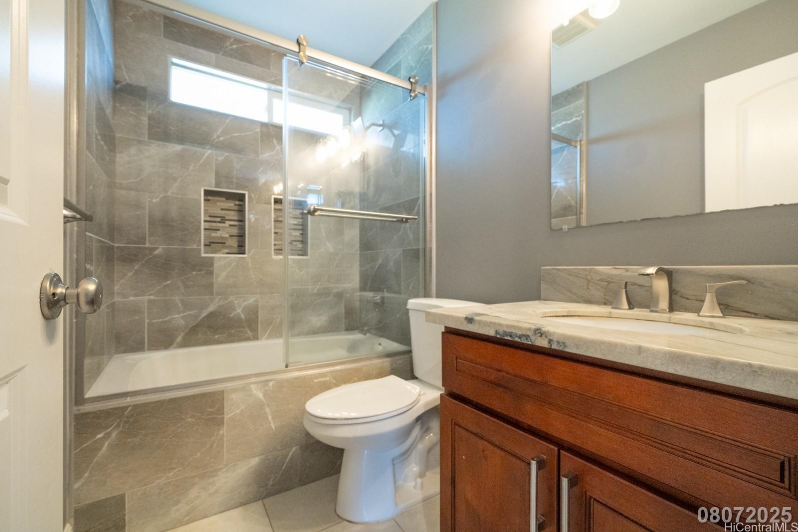 91-1014 Alepa Street Kapolei, HI 96707 - Photo 18 of 25 a bathroom with a granite countertop sink toilet and shower