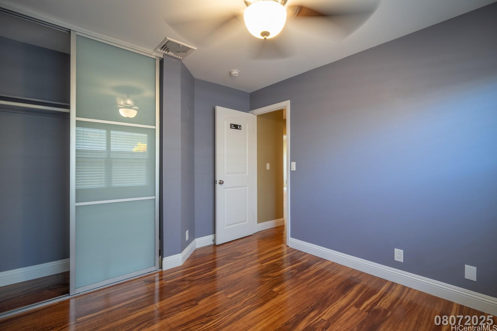 91-1014 Alepa Street Kapolei, HI 96707 - Photo 20 of 25 a view of an empty room with wooden floor and a window
