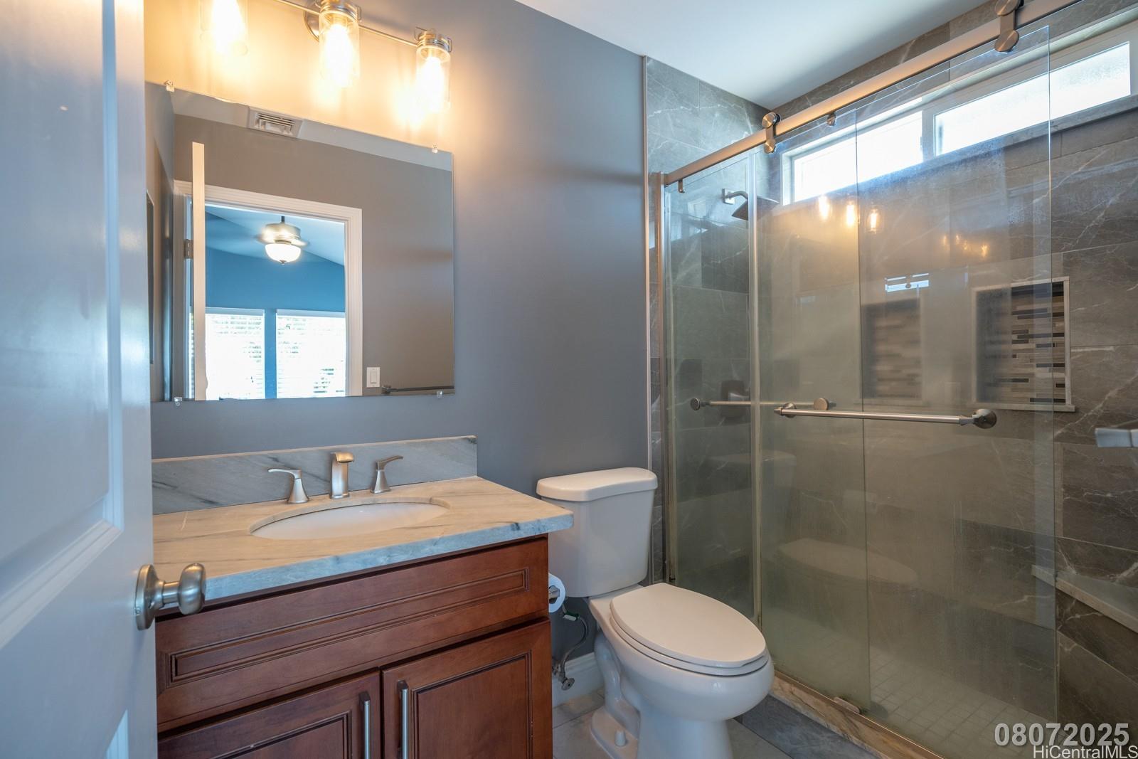 91-1014 Alepa Street Kapolei, HI 96707 - Photo 24 of 25 a bathroom with a granite countertop sink toilet and shower