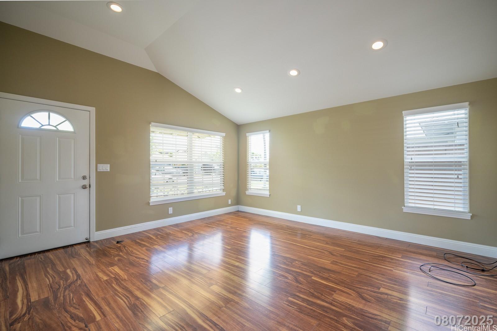 91-1014 Alepa Street Kapolei, HI 96707 - Photo 4 of 25 a view of an empty room with wooden floor and a window