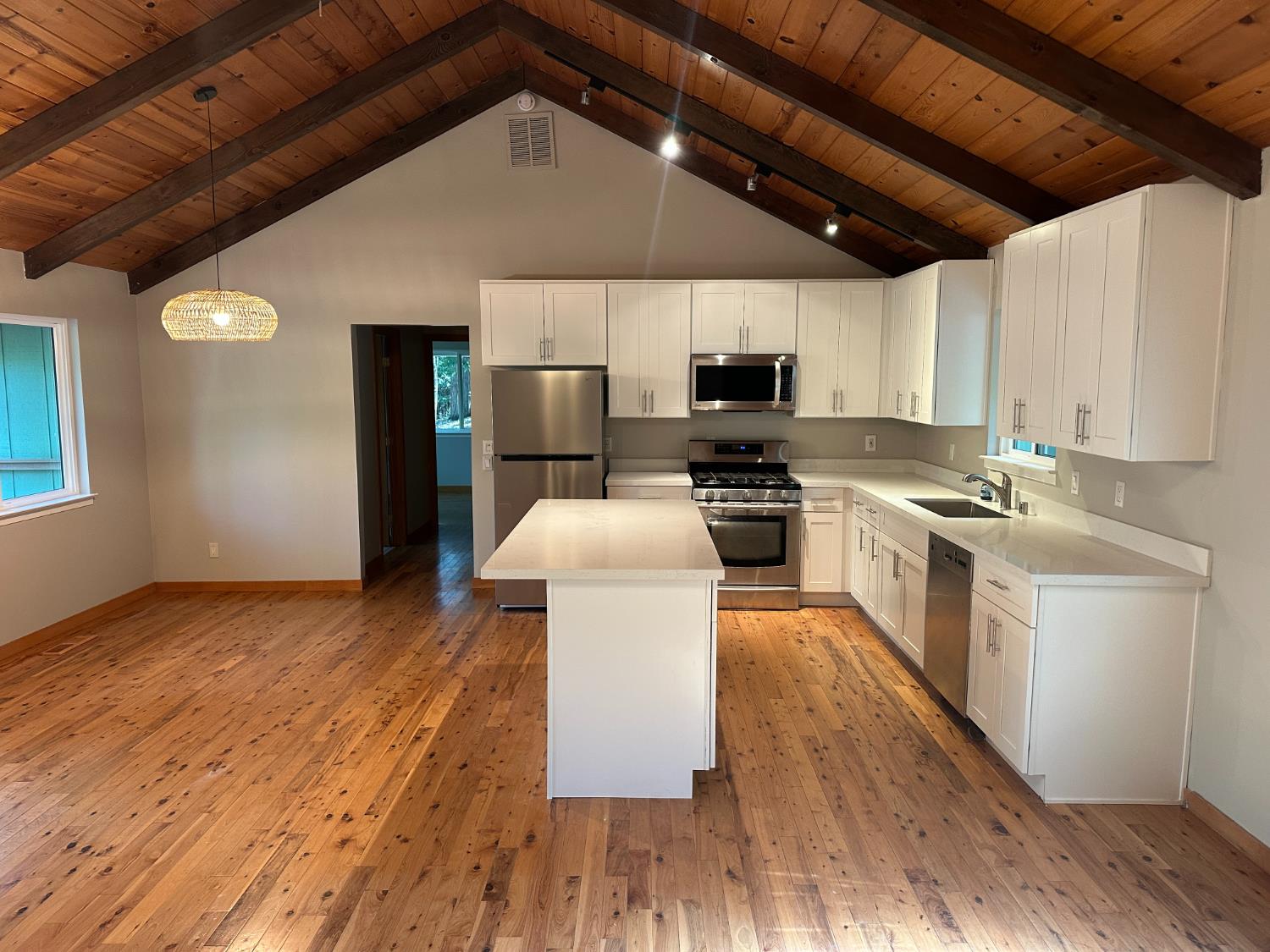 5570 5 Spot Road Placerville, CA 95667 - Photo 15 of 38 a kitchen with stainless steel appliances a microwave a stove a sink dishwasher a refrigerator and cabinets with wooden floor
