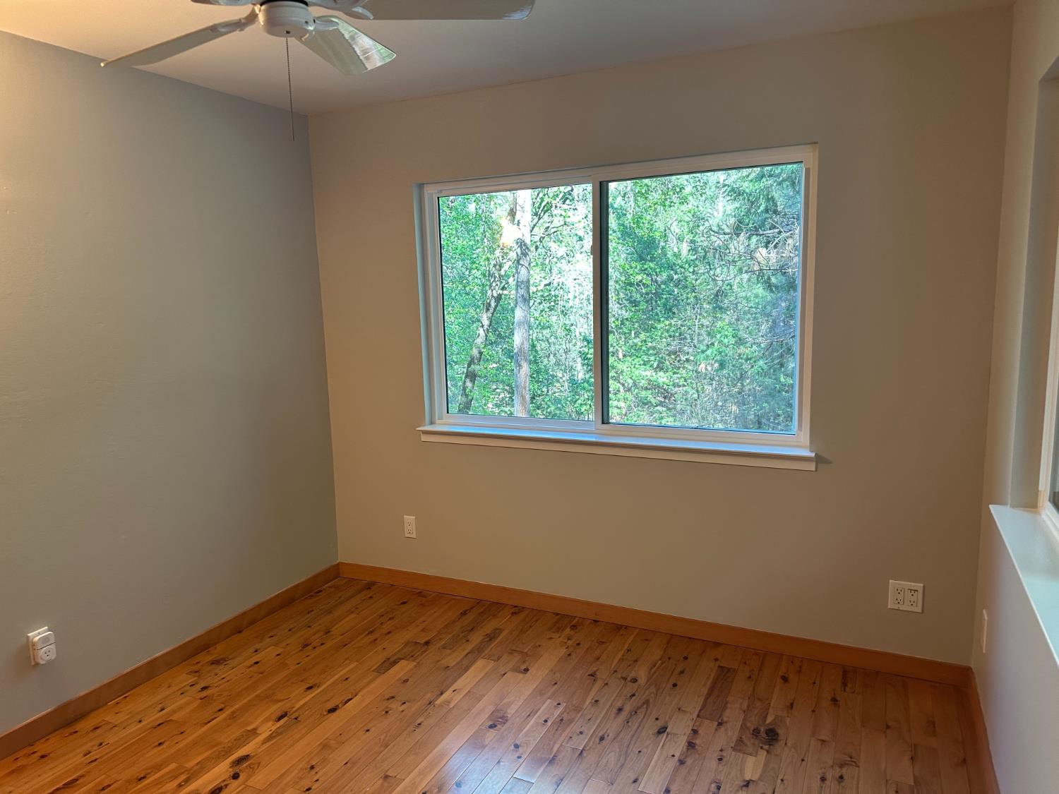 5570 5 Spot Road Placerville, CA 95667 - Photo 34 of 38 a view of an empty room with wooden floor and a window