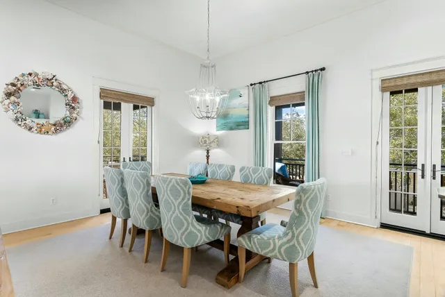 a kitchen with stainless steel appliances granite countertop a stove a sink a microwave a dining table and chairs