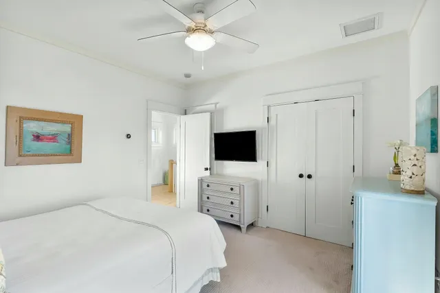 a view of swimming pool with outdoor seating and trees in the background