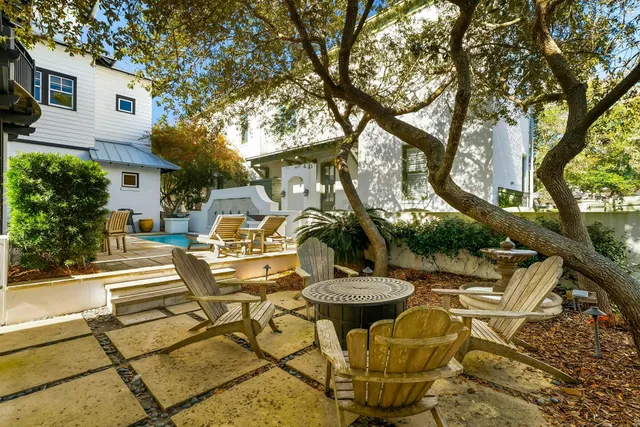 a kitchen with stainless steel appliances kitchen island granite countertop furniture a refrigerator a sink and white cabinets