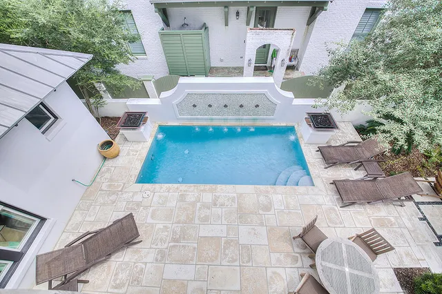 a large bed sitting in a bedroom next to a window