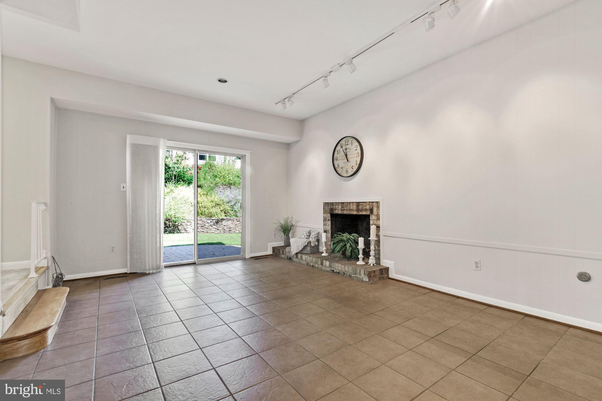 1010 Cannon Road Silver Spring, MD 20904 - Photo 8 of 31 Large family room with a cozy brick fireplace