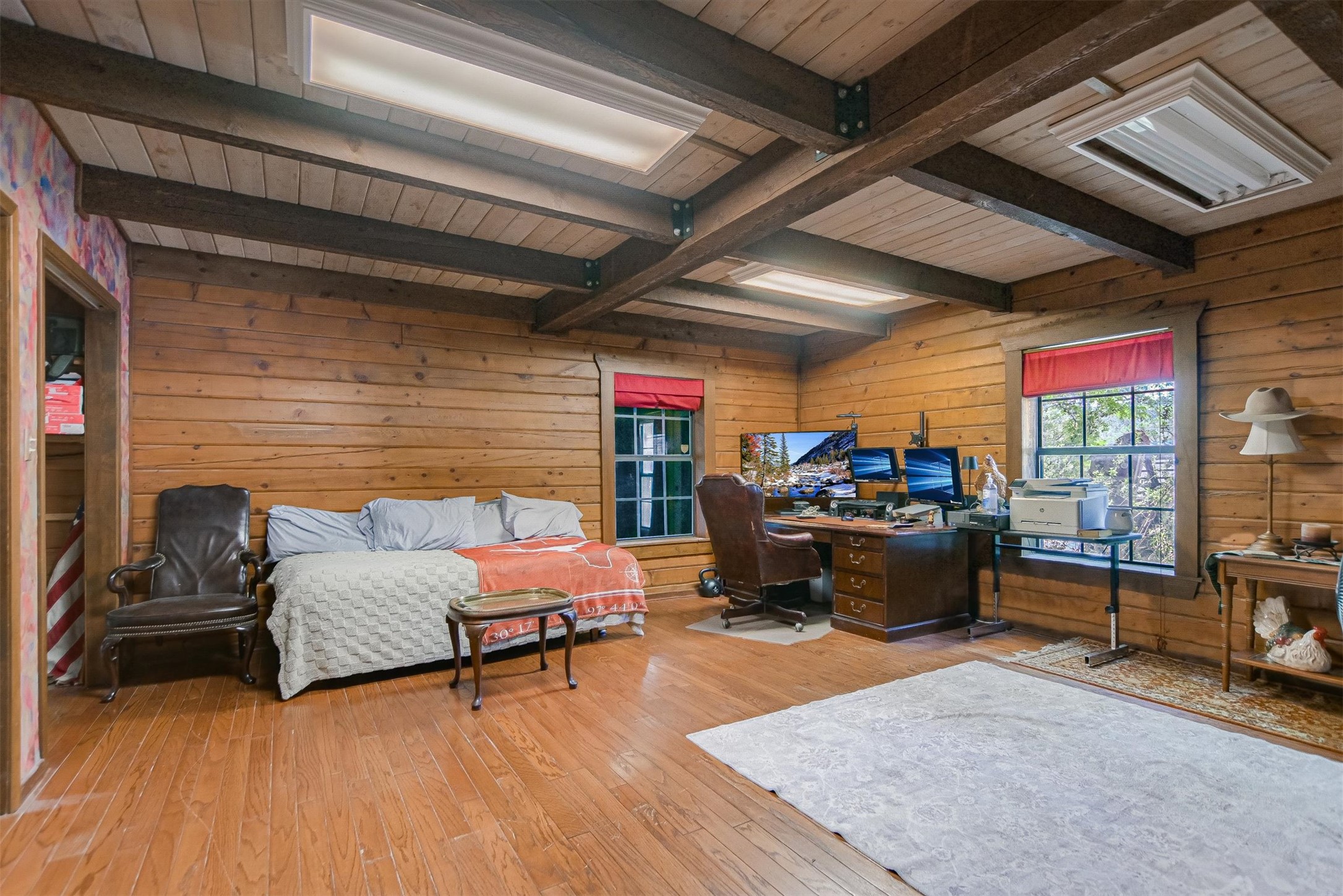 12711 Rr, Unit 12 Wimberley, TX 78676 - Photo 8 of 20 Located on the main floor, the primary bedroom offers a spacious layout with views of the surrounding trees